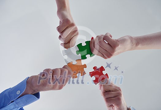 Group of business people assembling jigsaw puzzle and represent team support and help concept Group of business people assembling jigsaw puzzle and represent team support and help concept