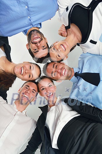 business people group joining hands and representing concept of friendship and teamwork, low angle view business people group joining hands and representing concept of friendship and teamwork, low angle view