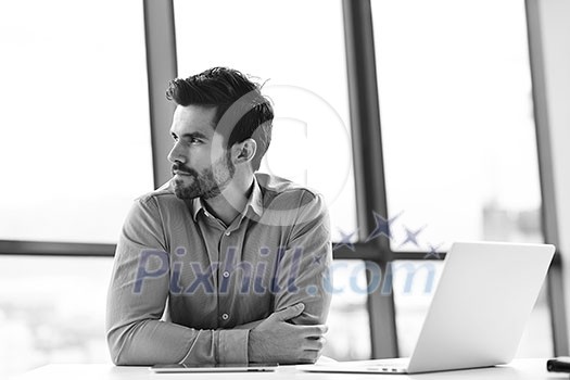 happy young business man work in modern office on computer happy young business man work in modern office on computer