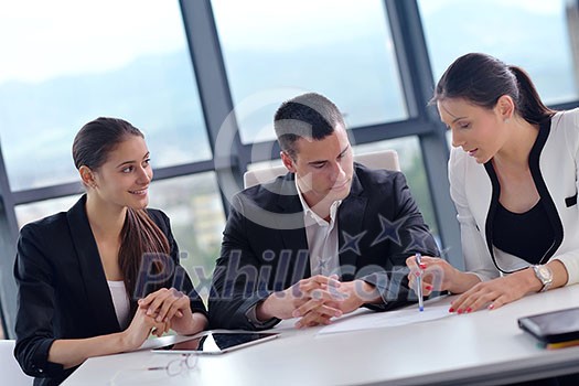 Group of happy young business people in a meeting at office Group of happy young business people in a meeting at office
