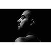 young nude adult man face portrait in dark