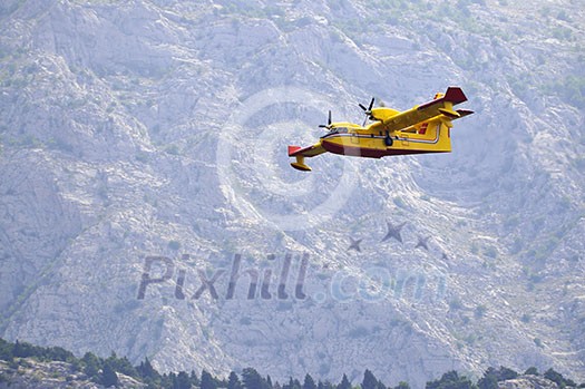 Airplane droping water on fire on island