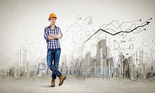 Image of man builder with arms crossed on chest against urban scene Image of man builder with arms crossed on chest against urban scene