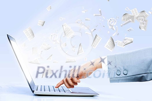 Close up image of laptop and human hands typing on keyboard