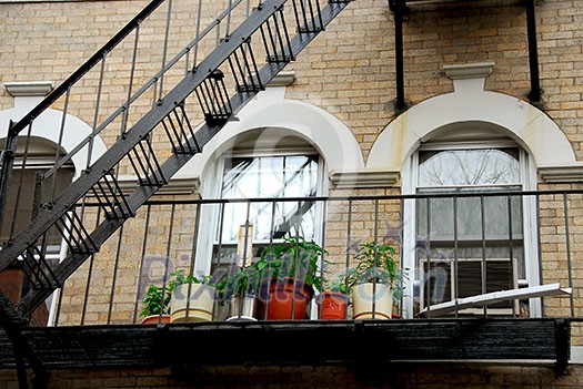 Fragment of a brick house in Boston historical North End, metal fire escape Fragment of a brick house in Boston historical North End, metal fire escape