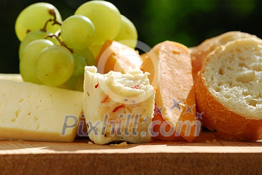 Assorted cheeses with grapes and white bread Assorted cheeses with grapes and white bread