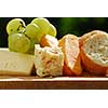 Assorted cheeses with grapes and white bread