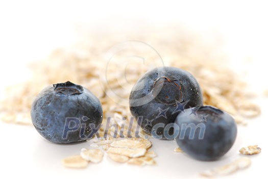 Blueberries and oats macro on white background Blueberries and oats macro on white background