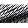 Abstract background of perforated metal with very shallow dof