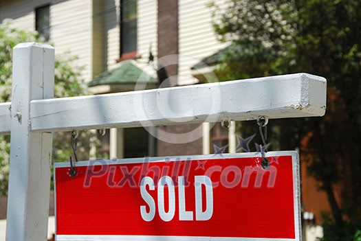Closeup on sold sign near residential house Closeup on sold sign near residential house