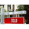Closeup on sold sign near residential house
