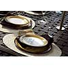 Table setting on a patio table with plates and martini glasses