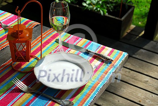 Table setting outside on a deck Table setting outside on a deck