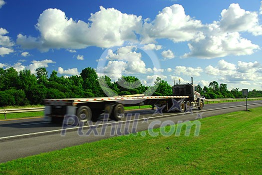 Fast moving truck with red container on highway, blurred because of motion Fast moving truck with red container on highway, blurred because of motion