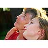 Portrait of a grandmother and granddaughter looking up with hope