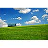 Barn in summer farm field,  deep blue sky