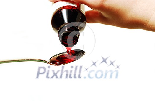 Cough syrup poured into a spoon Cough syrup poured into a spoon