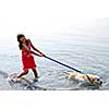 Happy girl playing with her dog in water