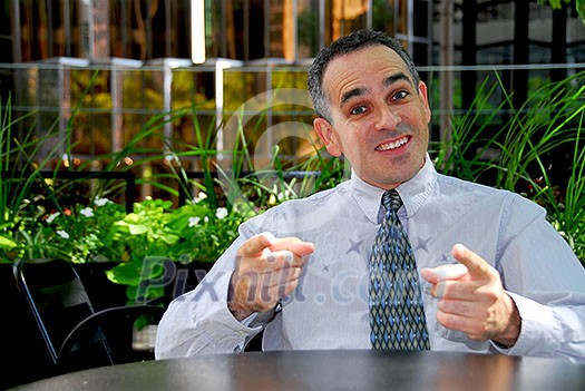 Businessman in outdoor cafe explaining an idea Businessman in outdoor cafe explaining an idea