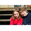 Grandmother and granddaughter sitting on a deck
