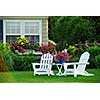 Two lawn chairs in a beautifl garden