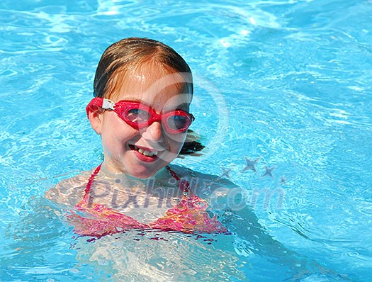Young girl in red goggles in swimming pool Young girl in red goggles in swimming pool