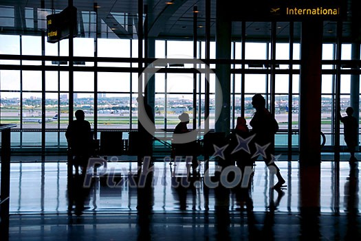 People waiting at the airport terminal People waiting at the airport terminal