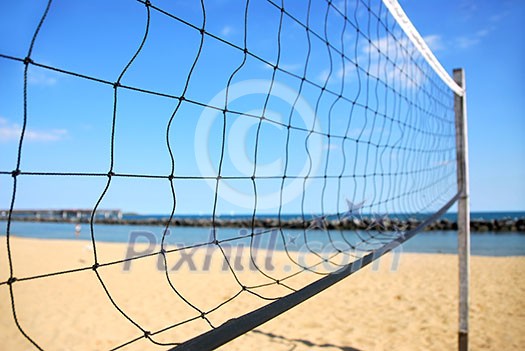 Beach volleyball net in perspective on a sandy beach Beach volleyball net in perspective on a sandy beach