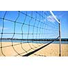 Beach volleyball net in perspective on a sandy beach