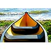 Yellow canoe on lake shore