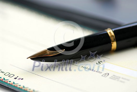 Gold fountain pen and cheque Gold fountain pen and cheque