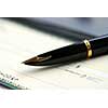 Gold fountain pen and cheque