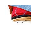Folded sweaters in a paper shopping bag on white background