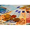 Background of bills and coin of european union currency, shallow dof