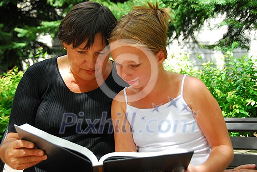 Grandmother and granddaughter reading a book Grandmother and granddaughter reading a book