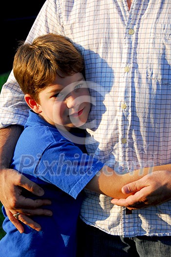 Little boy hugging his father Little boy hugging his father