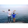 Father and son on a pier relaxing together