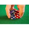 Close up on man's hand doing a pocker chip trick 'shuffle'