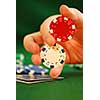 Close up on man's hand doing a pocker chip trick 'twirl'