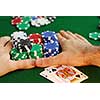 Poker player going 'all in' pushing his chips forward