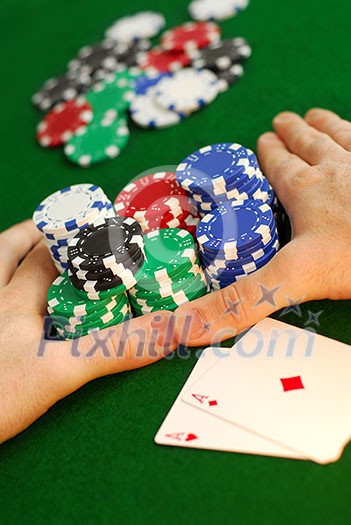 Poker player going 'all in' pushing his chips forward Poker player going 'all in' pushing his chips forward
