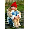 Portrait of a young girl sitting on a bench