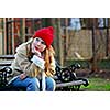 Portrait of a young girl sitting on a bench