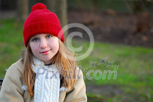 Portrait of a young girl sitting on a bench