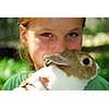 Portrait of a young girl holding a bunny outside
