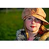 Portrait of a young girl wearing suede hat on green background