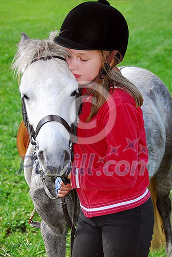 Young girl with a white pony at countryside Young girl with a white pony at countryside