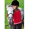 Young girl with a white pony at countryside