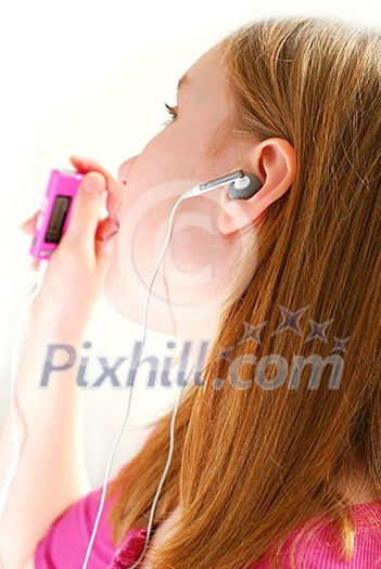 Young girl listening to music on her mp3 player white background Young girl listening to music on her mp3 player white background