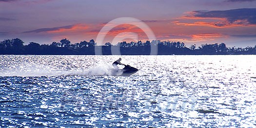 Man on jet ski at sunset Man on jet ski at sunset